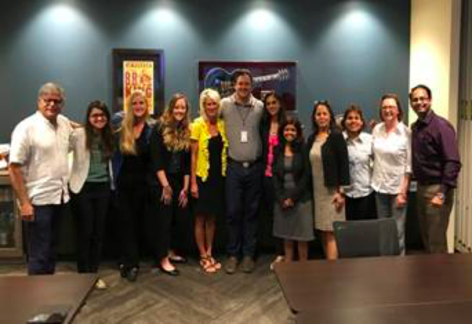 Brand USA India Global Office members posing in front of music memorabilia