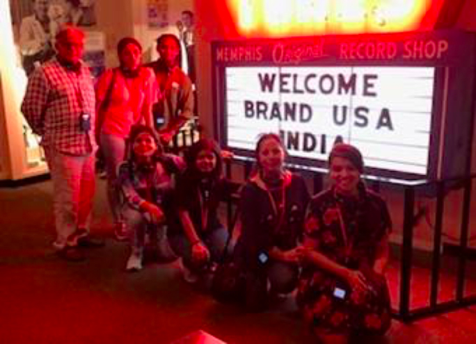 Brand USA India Global Office members next to a memorable record shop welcome sign