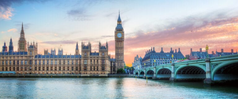 View of Big Ben, Westminster Bridge, and Houses of Parliament at sunset.