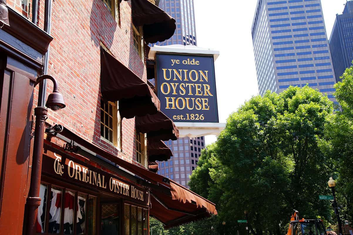 Historic Union Oyster House in Boston with city skyline in background.