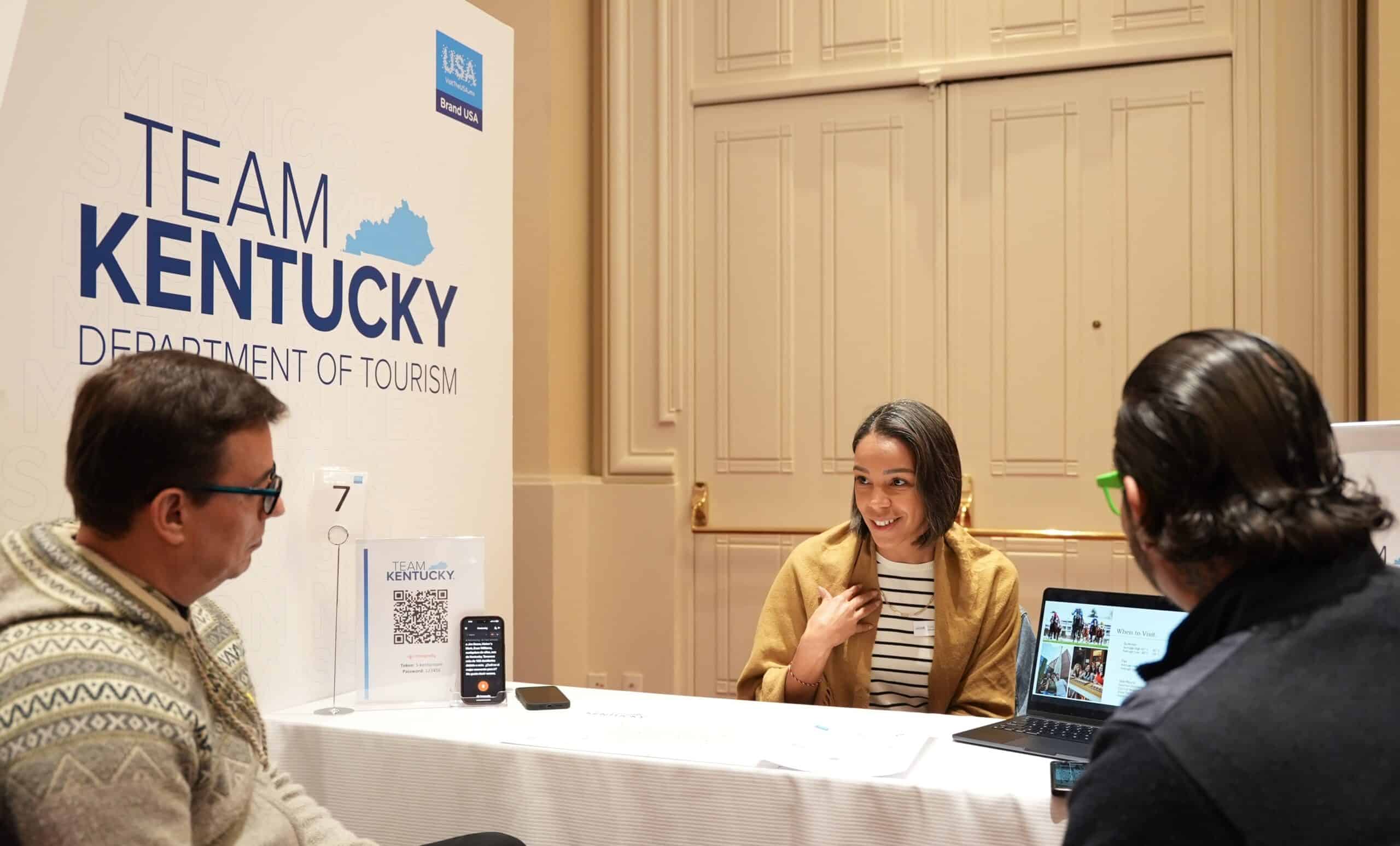 Team Kentucky representatives at tourism department meeting in a conference room.
